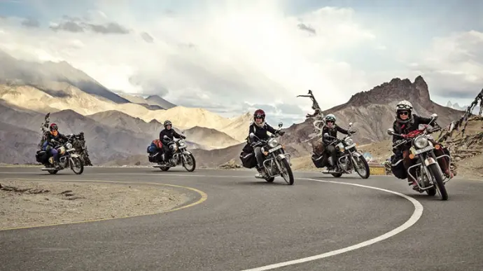 Women riders group on Ladakh mountain road by Mountain Junkey