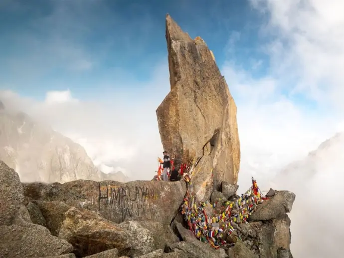 Trekker on rocky ridge, Kinnaur Himalayan adventure in Himachal Pradesh