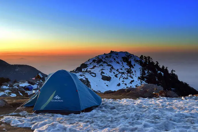Frozen Kareri Lake with snow-capped Dhauladhar peaks, McLeodganj winter trek