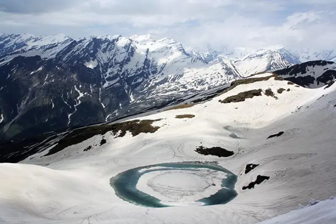 Green meadow trail leading to Bhrigu Lake, Himalayan trek near Manali