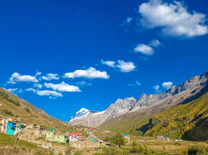 Chabi Waterfall near Sural Bhatori surrounded by wildflowers and rugged Himalayan terrain - Mountain Junkey