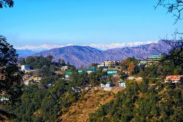 Green terraced hills and village view in Mussoorie by Mountain Junkey