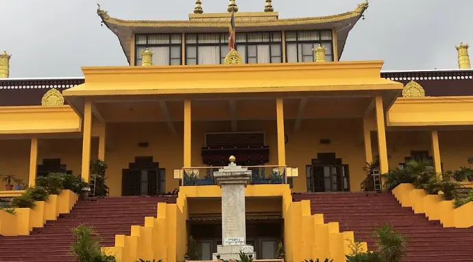 Courtyard of Dharamshala monastery with Dhauladhar mountains in background - Mountain Junkey
