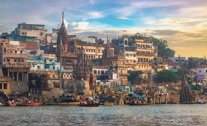 Panoramic view of Varanasi ghats with riverside temples at sunrise - Mountain Junkey