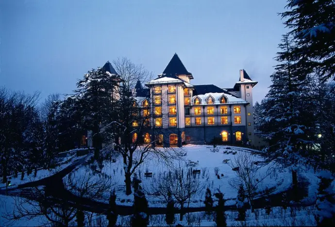 Wildflower Hall Shimla garden view with Mountain Junkey branding